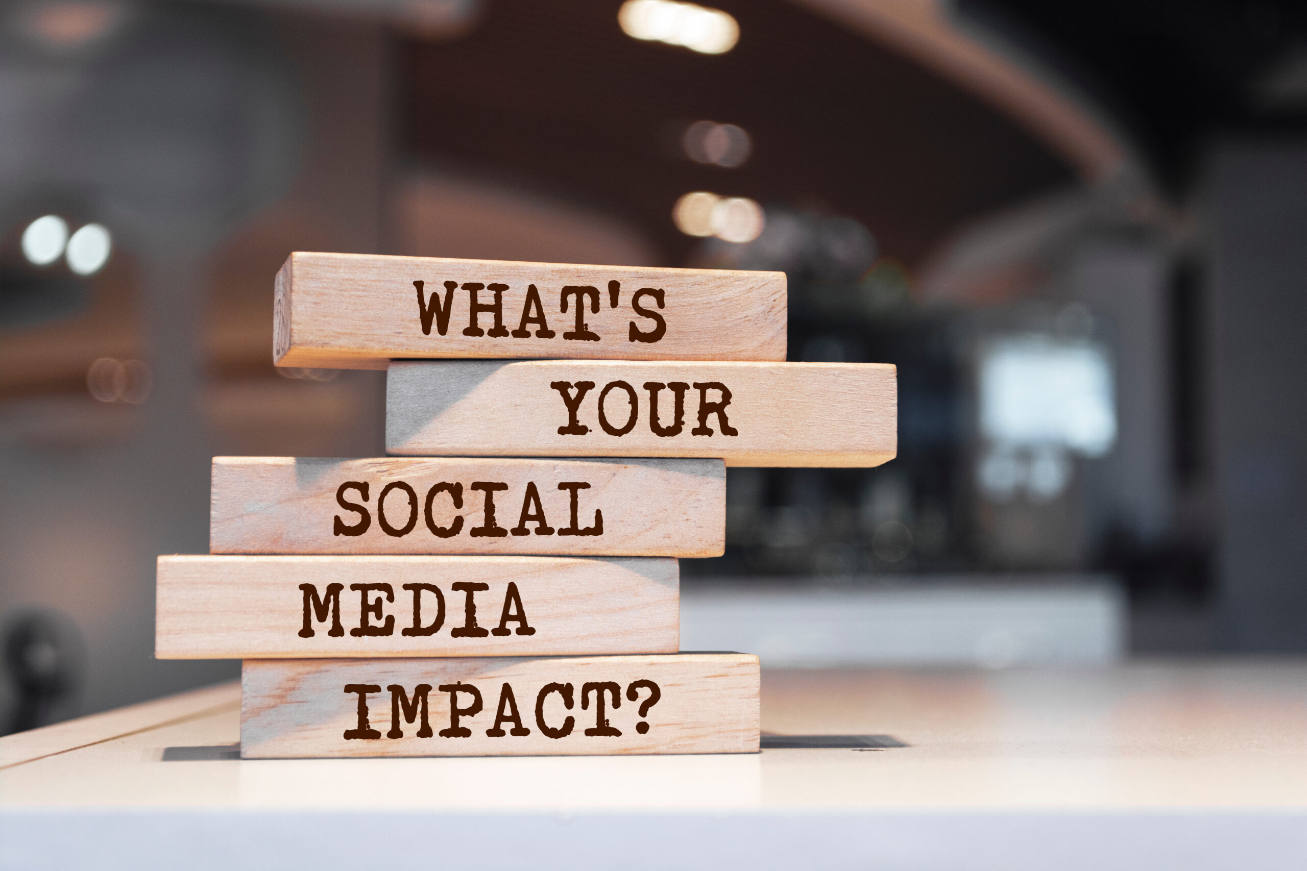 Wooden blocks stack with text: 'What's Your Social Media Impact?'